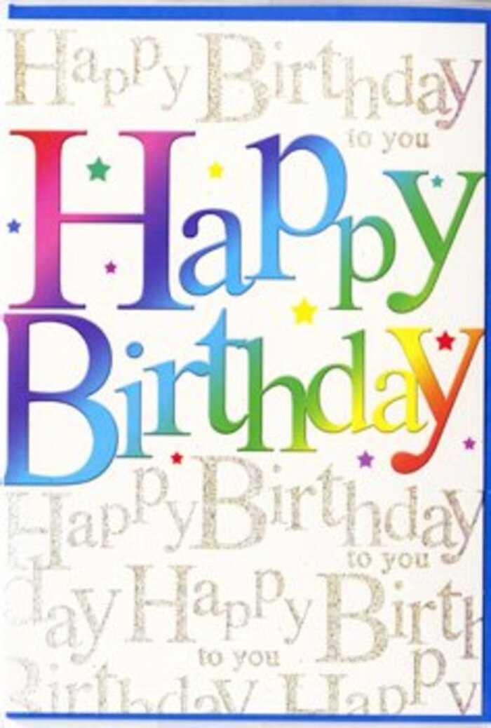 In this photograph, a joyful birthday card stands as the focal point, its design echoing the same mix of tradition and playfulness you find wandering from Blackheath station toward the heath on a clear afternoon. The central feature is the phrase Happy Birthday, spelled out in generous, rounded letters that arch slightly across the card, giving a sense of movement and rising celebration. Each letter is filled with a flowing gradient of colour, transitioning from bold reds and raspberry pinks into ocean blues, leafy greens, and mellow golds. The hues bleed gently into each other, like the soft blending of petals in a vibrant floral display, lending the text an almost luminous quality. The surface looks smooth and slightly reflective, suggesting a premium, satin-finished cardstock that catches the light without glaring. Behind the main greeting, a field of fine, gold-toned handwriting repeats Happy Birthday to you over and over, the loops and swirls forming a decorative pattern rather than a block of text. This script shimmers subtly, as if dusted with the lightest touch of glitter, calling to mind the way early morning sun can sparkle on the grass of Blackheath Common. Tiny starbursts and confetti specks in matching rainbow shades are scattered between the letters, adding a sense of confetti falling mid-celebration. The overall impression is of a card that feels both exuberant and carefully crafted, ideal for pairing with a colourful bouquet from Flowers Blackheath for same-day birthday delivery across the local area, bringing not just a message, but an uplifting visual experience to whoever opens it.